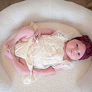 Lydia joined the competition — help win amazing prizes! baby, infant, lace, headband, bow, soft_fabric, cozy, comfortable, lying_down, cute, newborn, portrait, indoor, fluffy, blanket, sleepy, peaceful, child, person, small