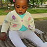 Aliyaah Khira participe au concours pour gagner de l'argent avec cette photo : toddler, child, park, bench, braided_hair, hair_clips, cardigan, flower_decor, white_leggings, outdoor, greenery, daylight, sitting, metal_bench, cute, serious_expression, young_child, casual_clothing, nature, peaceful