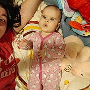 Roselynn joined the competition — help win amazing prizes! baby, child, infant, siblings, portrait, selfie, smiling, playful, face, eyes, pajamas, pink_clothing, cat_pattern, blanket, bed, stuffed_animal, plush_bunny, toys, indoor, family