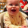 Roselynn joined the competition — help win amazing prizes! baby, child, infant, smiling, laughing, happy, portrait, high_chair, sitting, indoors, home, heart_pattern, pajamas, clothing, stuffed_animals, furniture, close_up, face, joyful, family_scene