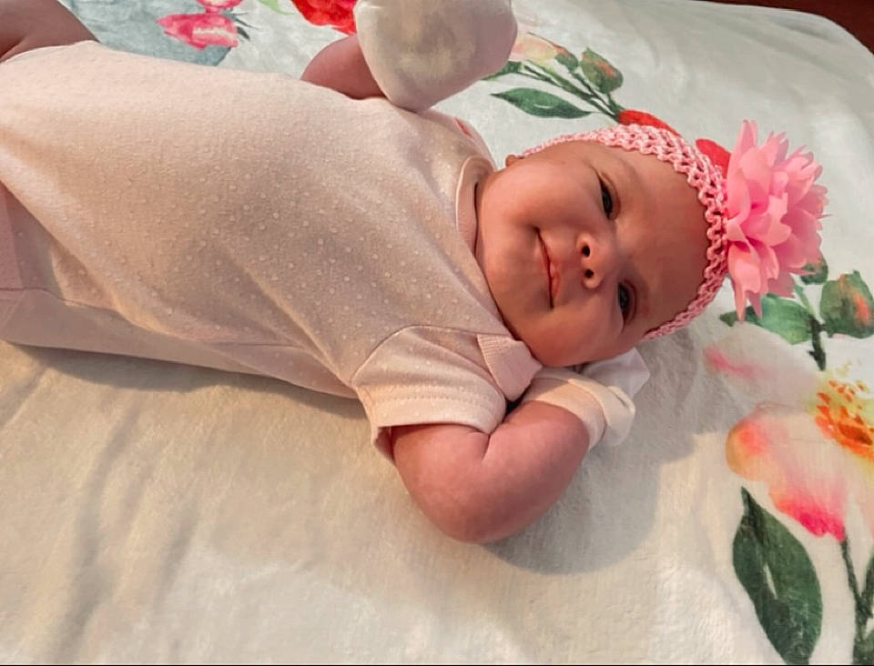 Azlyn joined the competition — help win amazing prizes! baby, baby_products, baby_sleeping, baby_toddler_clothing, bedding, child, comfort, event, flower, grass, hat, head, headgear, headwear, linens, lip, person, petal, plant, rose