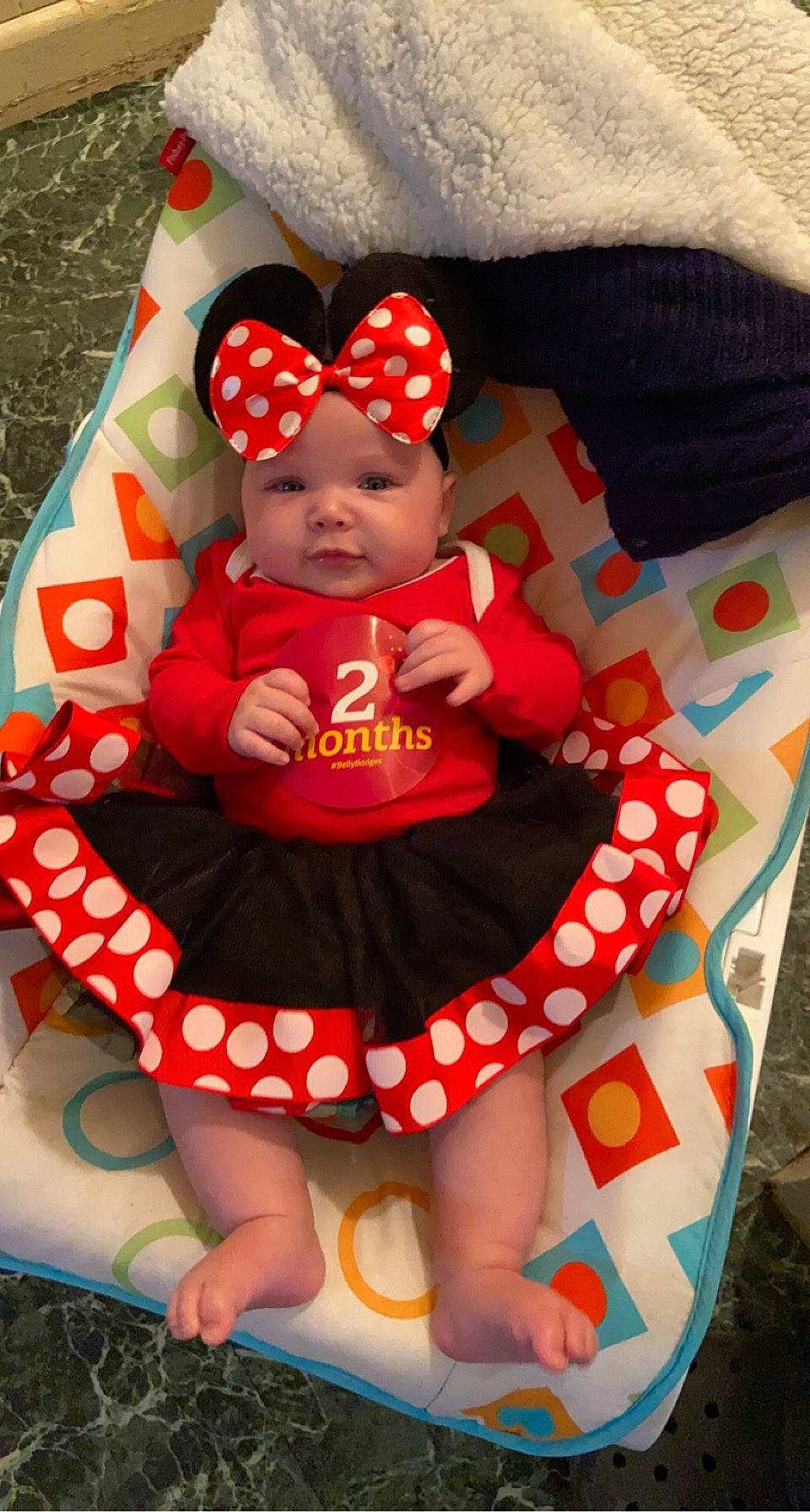 Azlyn is registered to the contest to win money with this photo: baby, baby_products, baby_toddler_clothing, comfort, design, fun, happy, hat, headwear, lap, linens, magenta, pattern, person, pink, product, red, sleeve, t_shirt, textile