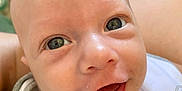 Noam participe au concours pour gagner de l'argent avec cette photo : baby, closeup, smile, face, eyes, infant, skin, mouth, expression, child, cute, indoor, person, head, joy, young, apparel, white_clothing, happy, portrait