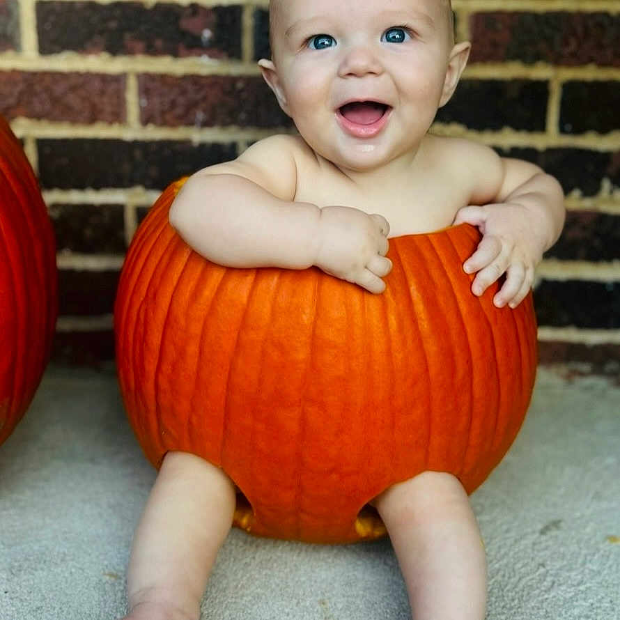 Michael is registered to the contest to win money with this photo: architecture, baby, building, clothing, costume, face, food, happy, head, outdoors, person, photography, plant, portrait, pottedplant, produce, pumpkin, shelter, squash, vegetable