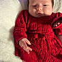 Kamila joined the competition — help win amazing prizes! baby, infant, red_dress, bow, blanket, sleepy, cute, chubby_cheeks, hand, foot, cozy, knitwear, portrait, indoor, soft_texture, newborn, child, person, relaxing, closeup