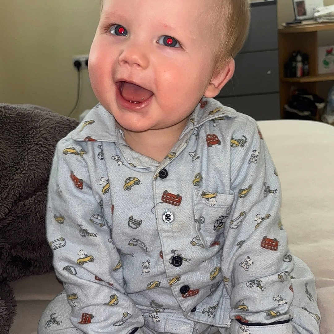 Carson is registered to the contest to win money with this photo: baby, bed, bedroom, clothing, computerhardware, electronics, face, furniture, happy, hardware, head, indoors, monitor, pajamas, person, photography, portrait, room, screen, tv