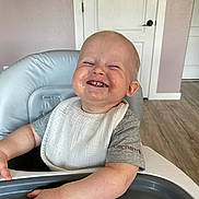 Thomas joined the competition — help win amazing prizes! toddler, child, smiling, high_chair, bib, messy, food, face, happy, indoor, wood_floor, door, short_sleeve_shirt, carhartt, baby, hands, sitting, cheerful, light, home