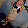child, girl, smile, bow, dress, shoes, indoor, plant, poster, wall, happy, pose, joyful, clothing, footwear, hair, cute, young, expression, home