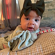 Kyara joined the competition — help win amazing prizes! baby, infant, child, portrait, close_up, smiling, wide_eyed, bow, headband, blanket, cushion, bracelet, beads, personalized, indoors, cozy, home, seated, face, photography