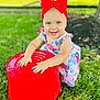toddler, child, red_bow, floral_dress, grass, outdoor, bucket, toy, happy, smiling, playing, sunny, nature, greenery, baby, cute, hands, headband, summer, portrait