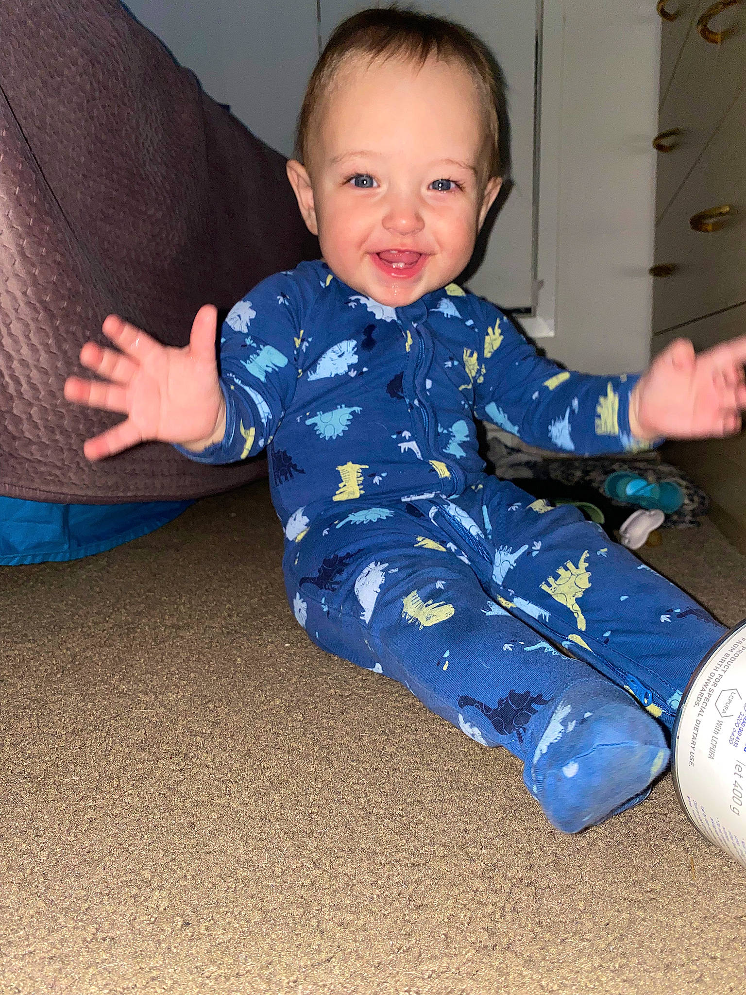 Benjamin is registered to the contest to win money with this photo: baby, baby_toddler_clothing, blue, child, comfort, electric_blue, eye, face, floor, flooring, fun, happy, head, pattern, person, sitting, sleeve, smile, sock, t_shirt