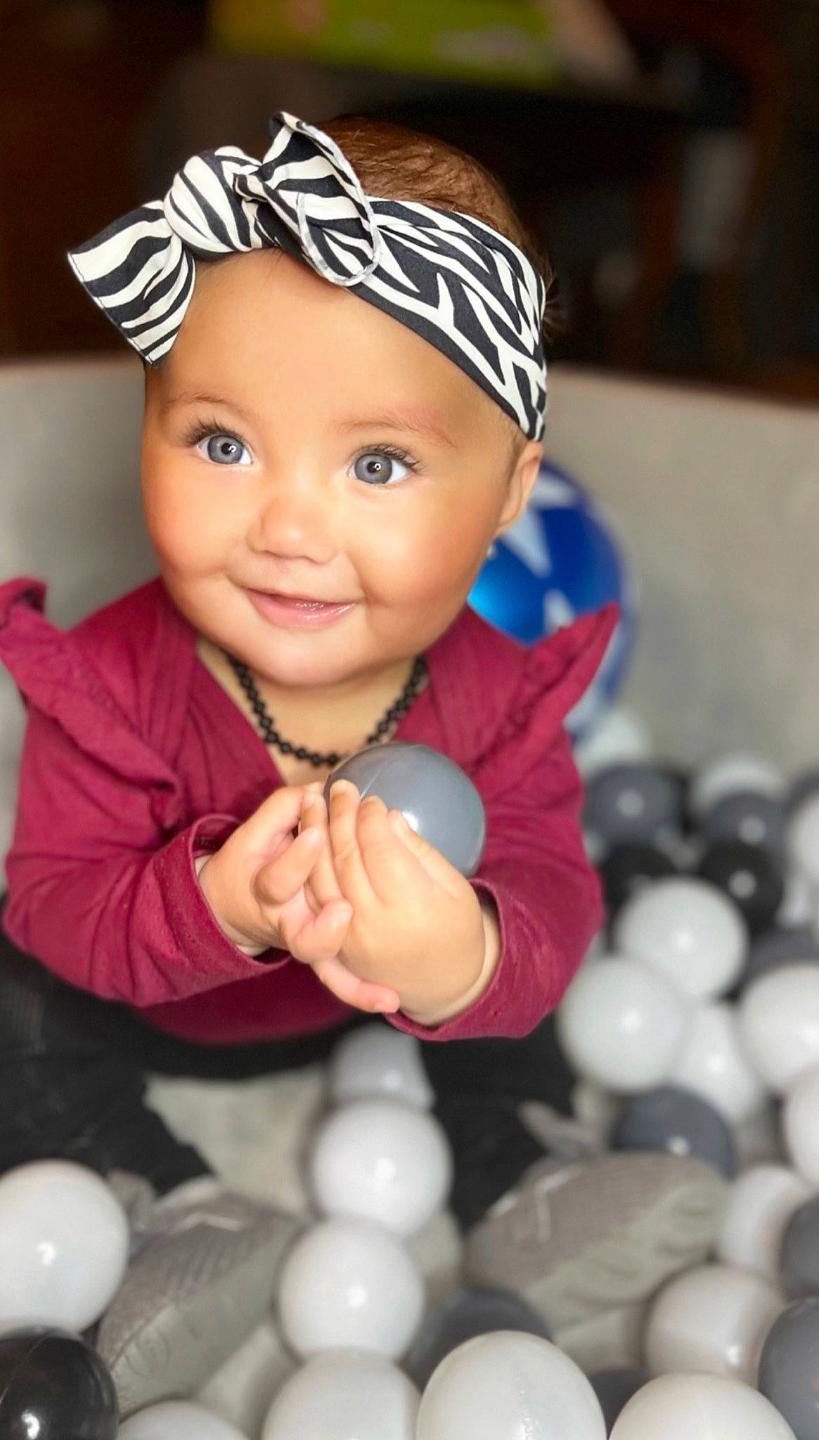 Birdie is registered to the contest to win money with this photo: baby, baby_toddler_clothing, beauty, cap, facial_expression, finger, fun, gesture, happy, headwear, human, joy, light, organ, people, person, photograph, product, skin, smile
