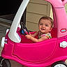 Addilyn joined the competition — help win amazing prizes! toddler, child, toy_car, pink, steering_wheel, outdoor, concrete_floor, smiling, happy, short_hair, plastic_toy, vehicle, playtime, casual_clothing, daylight, young_child, small_vehicle, fun, cute, portrait