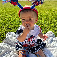 Addilyn is registered to the contest to win money with this photo: baby, child, outdoor, grass, blanket, headband, beads, patriotic, red_white_blue, sunlight, cute, sitting, playing, portrait, summer, festive, star, accessory, clothing, nature