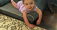 Addilyn joined the competition — help win amazing prizes! baby, child, smile, purple_clothing, dog_bed, carpet, wood_floor, table, home_interior, basket, earrings, happy, person, floor, indoor, furniture, crawling, cute, infant, plush