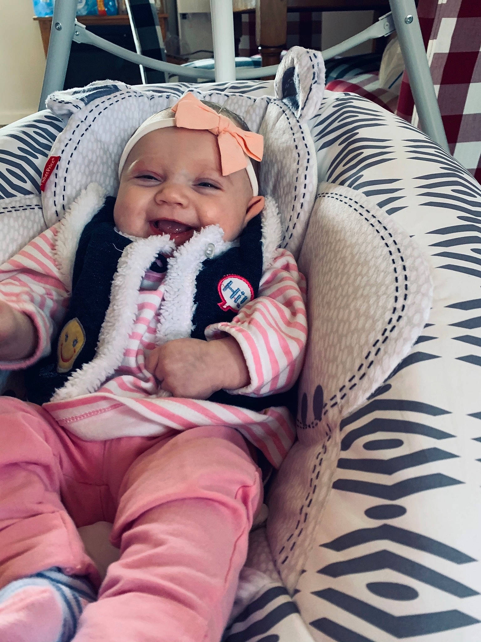 Addison is registered to the contest to win money with this photo: baby, baby_products, baby_safety, baby_toddler_clothing, cheek, child, comfort, eye, fun, happy, headwear, lap, linens, magenta, person, room, sitting, skin, smile, toddler