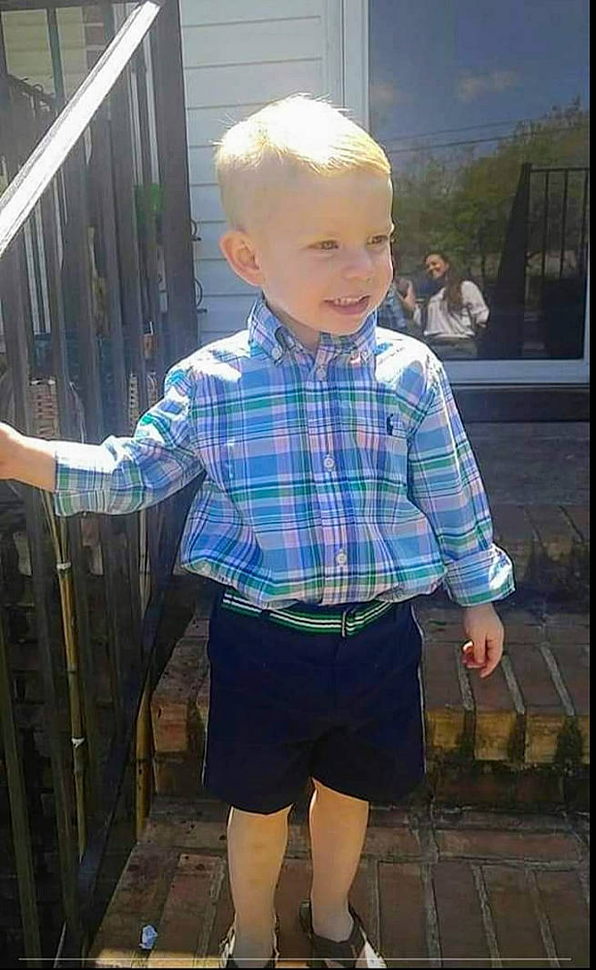 Kayden is registered to the contest to win money with this photo: blurred, child, cool, denim, dress_shirt, electric_blue, fun, happy, leisure, pattern, person, plaid, public_space, shoe, shorts, sleeve, smile, sneakers, standing, tartan