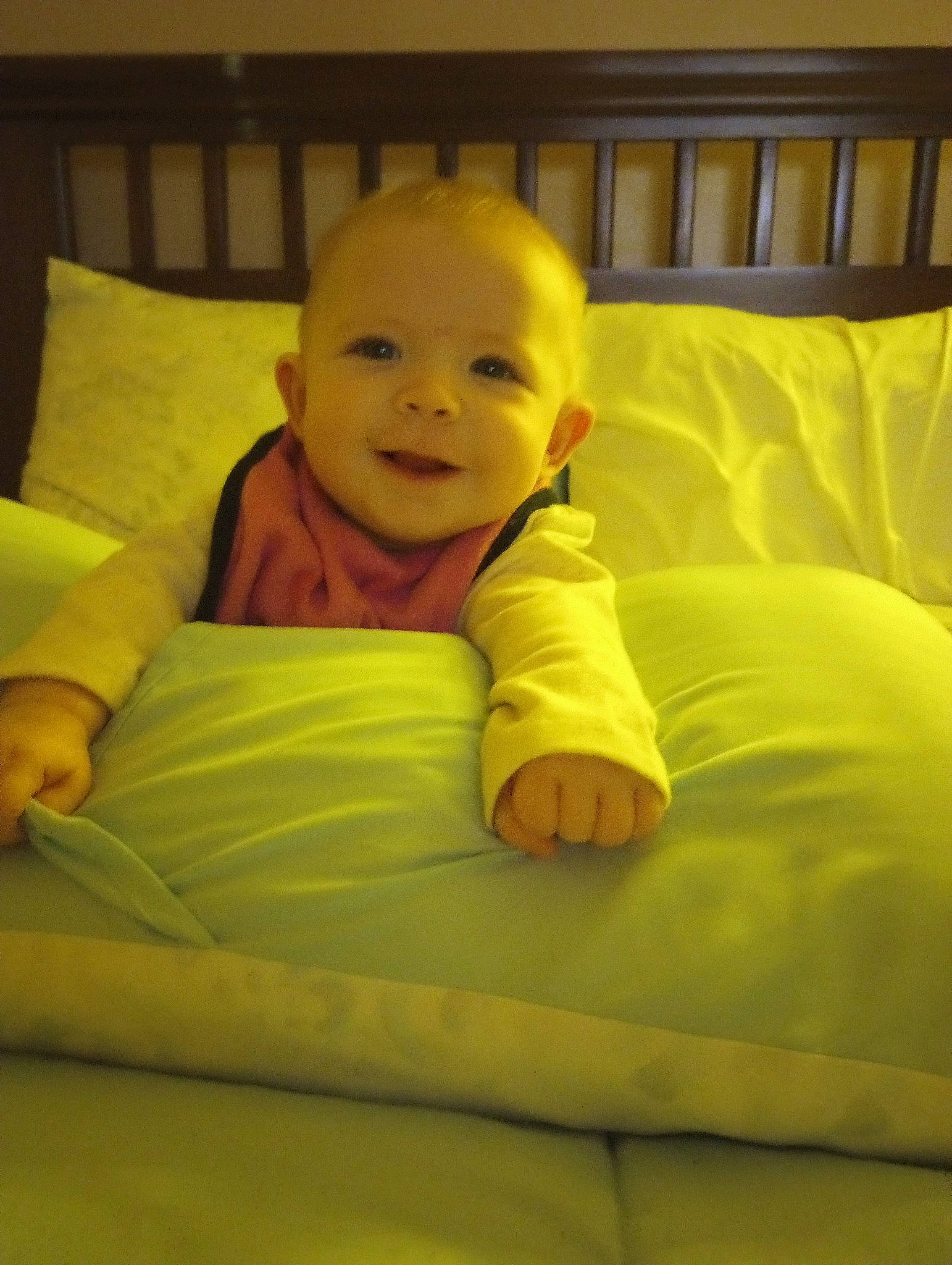 Ellyana is registered to the contest to win money with this photo: baby, baby_toddler_clothing, cheek, child, comfort, couch, finger, floor, flooring, fun, happy, linens, mammal, person, room, sitting, skin, smile, throw_pillow, toddler