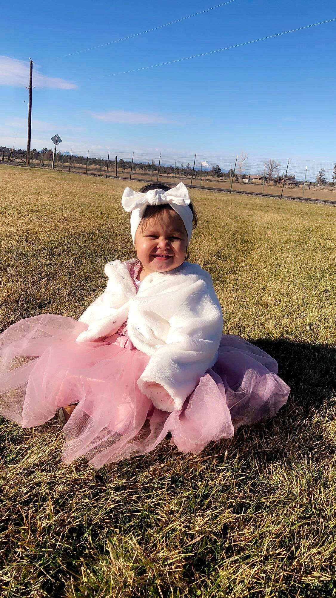 Karen is registered to the contest to win money with this photo: agriculture, baby_toddler_clothing, cloud, ecoregion, flash_photography, fun, gesture, grass, grassland, happy, headwear, joy, landscape, mammal, meadow, people_in_nature, person, plant, prairie, sky