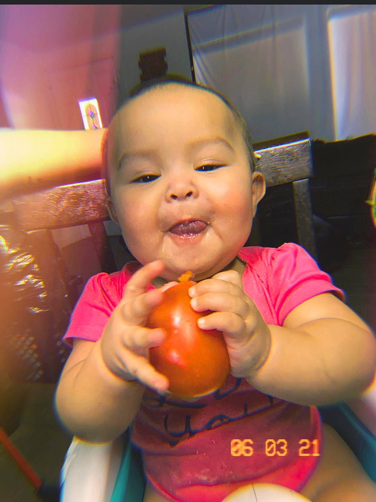 Karen is registered to the contest to win money with this photo: arm, cheek, chin, finger, fruit, fun, hand, happy, iris, lip, mouth, nail, natural_foods, neck, nose, orange, person, skin, smile, thumb