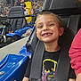 child, boy, smile, go_kart, seatbelt, racing, indoor, helmet_absent, background, girl, checkered_ceiling, mural, vehicle, seat, happy, fun, leisure, race_track, person, sport