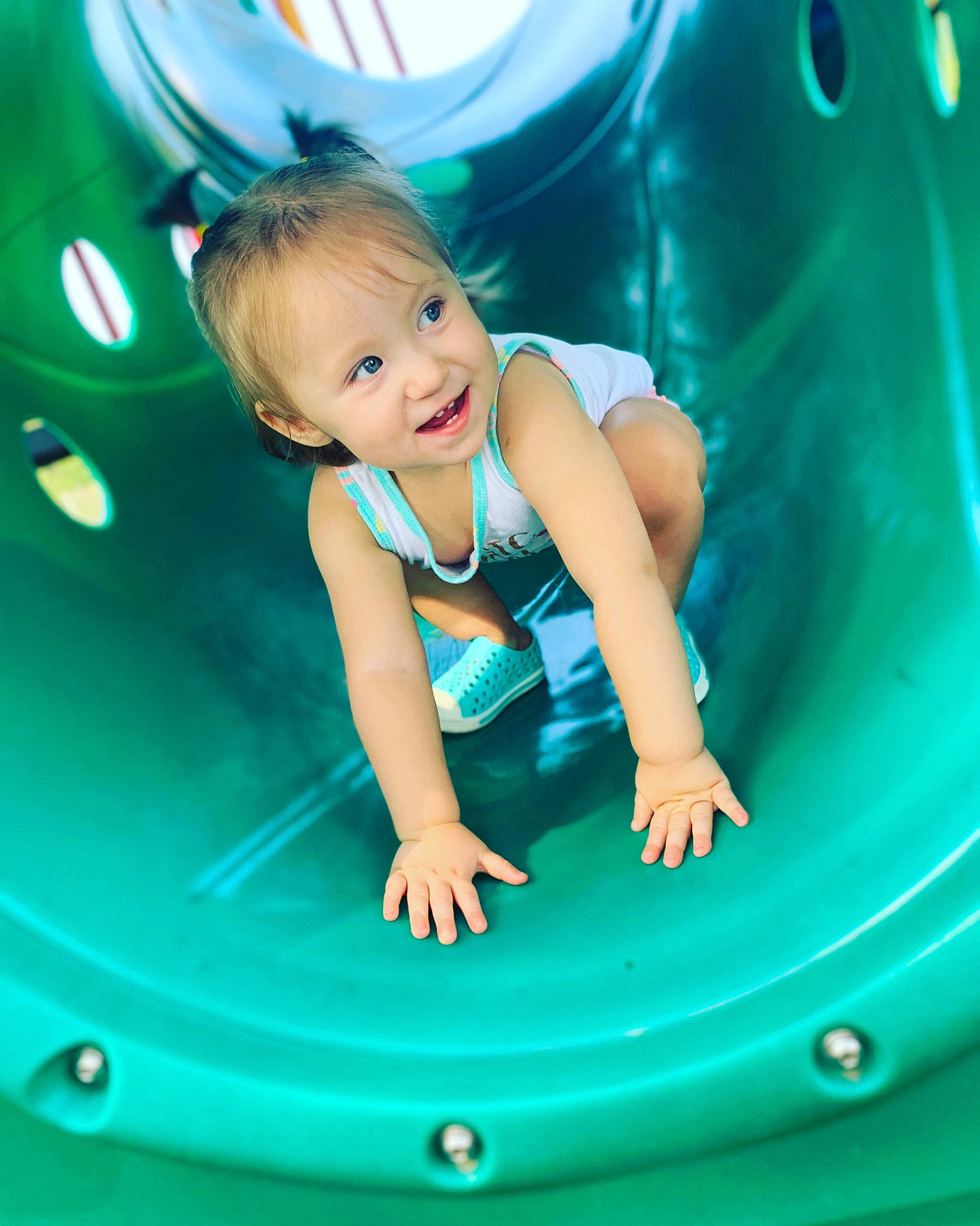 Serenity is registered to the contest to win money with this photo: amusement_park, aqua, arm, baby, baby_playing_with_toys, baby_toddler_clothing, child, child_model, chute, fun, leisure, person, play, playground, teal, toddler