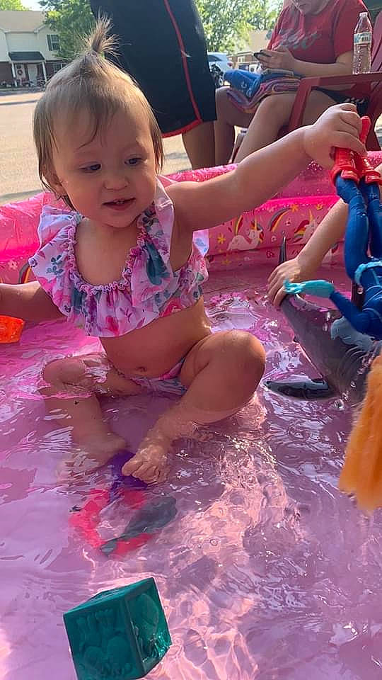 Serenity is registered to the contest to win money with this photo: arm, baby, baby_toddler_clothing, barefoot, bathing, child, foot, fun, hand, human_body, leisure, person, pink, play, spring_break, summer, swimwear, toddler, toe, vacation