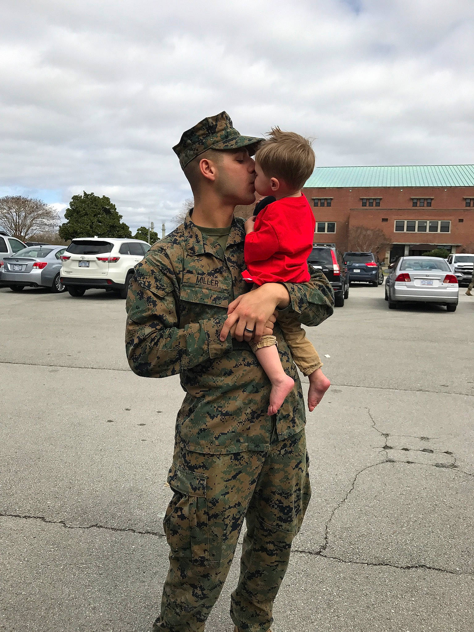 Bryden is registered to the contest to win money with this photo: army, child, headwear, infantry, interaction, law_enforcement, marines, military, military_camouflage, military_organization, military_person, military_uniform, non_commissioned_officer, person, soldier, troop, uniform, vehicle