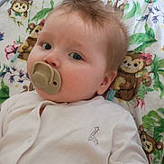 Thalia joined the competition — help win amazing prizes! baby, pacifier, blanket, monkey, pattern, infant, cute, child, toddler, white_clothing, soft_light, portrait, lying_down, hand, face, blue_eyes, hair, indoors, comfort, sleep_area