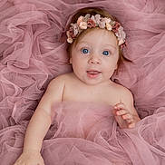 Elsa participe au concours pour gagner de l'argent avec cette photo : baby, infant, child, pink_tulle, flower_headband, blue_eyes, portrait, cute, soft_fabric, smiling, happy, skin, hand, face, lying_down, newborn, innocent, adorable, gentle_light, closeup