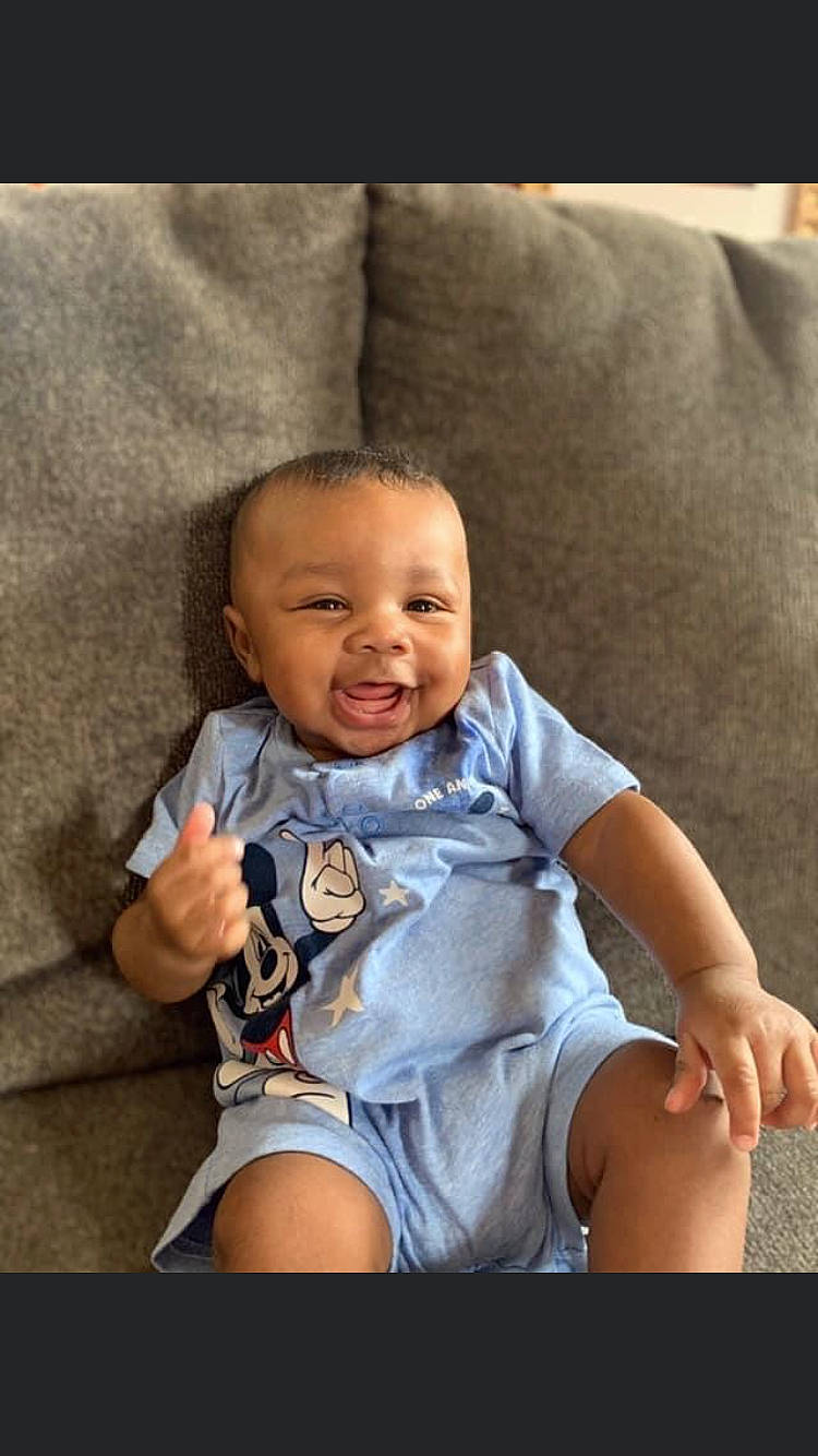 Noah is registered to the contest to win money with this photo: arm, baby_toddler_clothing, cheek, chin, clothing, comfort, cool, eye, finger, flash_photography, gesture, hand, happy, iris, joy, person, photograph, shoulder, skin, sleeve