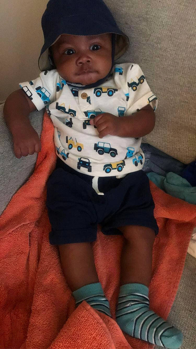 Noah is registered to the contest to win money with this photo: azure, baby, baby_toddler_clothing, chest, child, finger, fun, happy, headwear, human_leg, iris, knee, mouth, neck, pattern, person, shorts, sleeve, smile, thigh