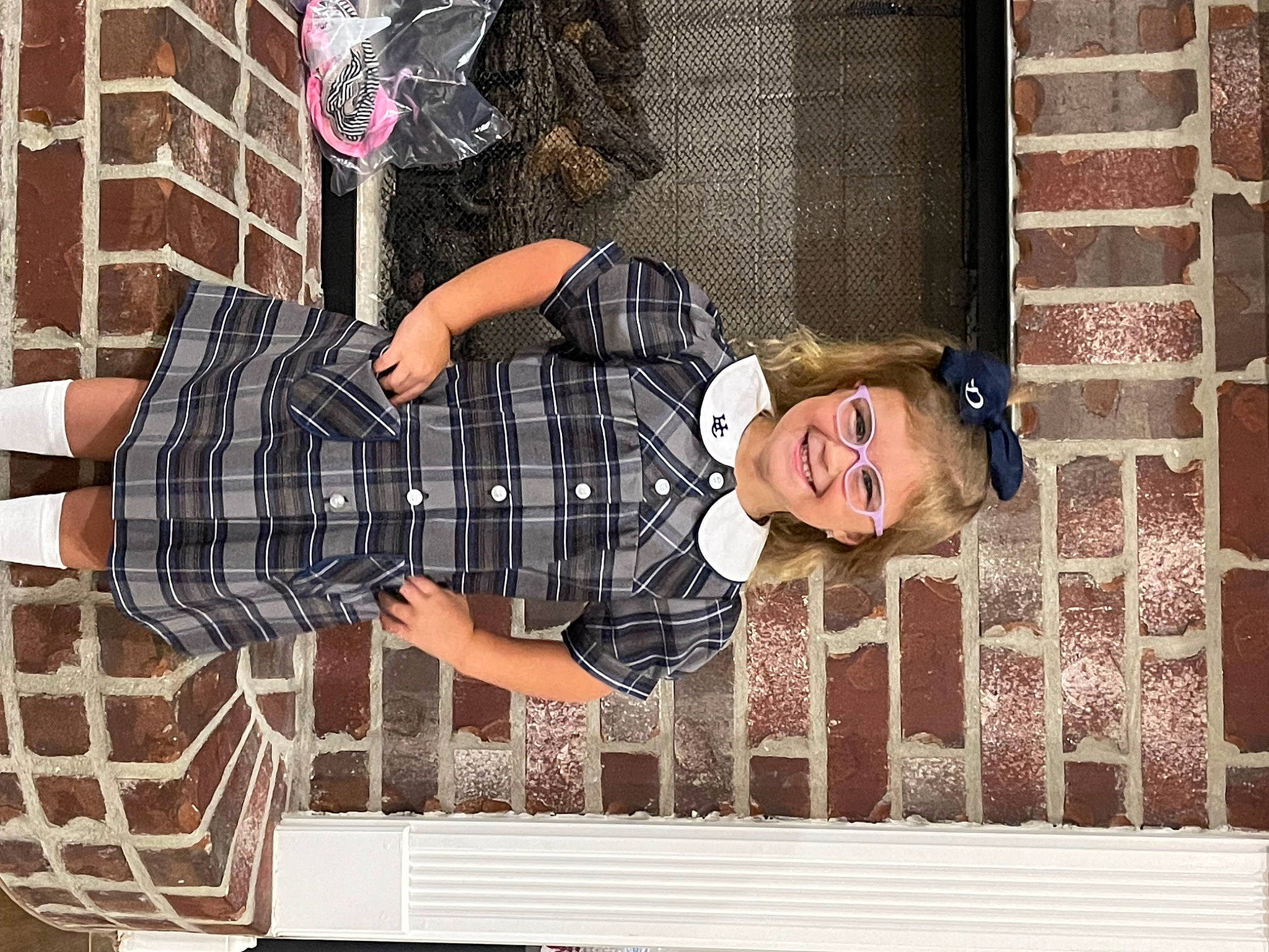 Demi joined the competition — help win amazing prizes! brick, child, dress, eyewear, fashion_accessory, happy, hat, human_leg, joy, pattern, person, plaid, room, sitting, smile, tartan, textile, thigh, vintage_clothing, waist