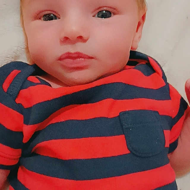 Phoenix is registered to the contest to win money with this photo: baby, baby_toddler_clothing, cheek, chin, cool, eye, eyebrow, eyelash, facial_expression, iris, lip, mammal, mouth, neck, no_expression, nose, skin, sleeve, t_shirt, toddler