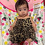 Mia is registered to the contest to win money with this photo: baby, child, leopard_print, pink_socks, minnie_mouse, baby_chair, polka_dots, curious, indoor, infant, cute, portrait, clothing, footwear, seated, toy_pattern, colorful, face, person, young_child
