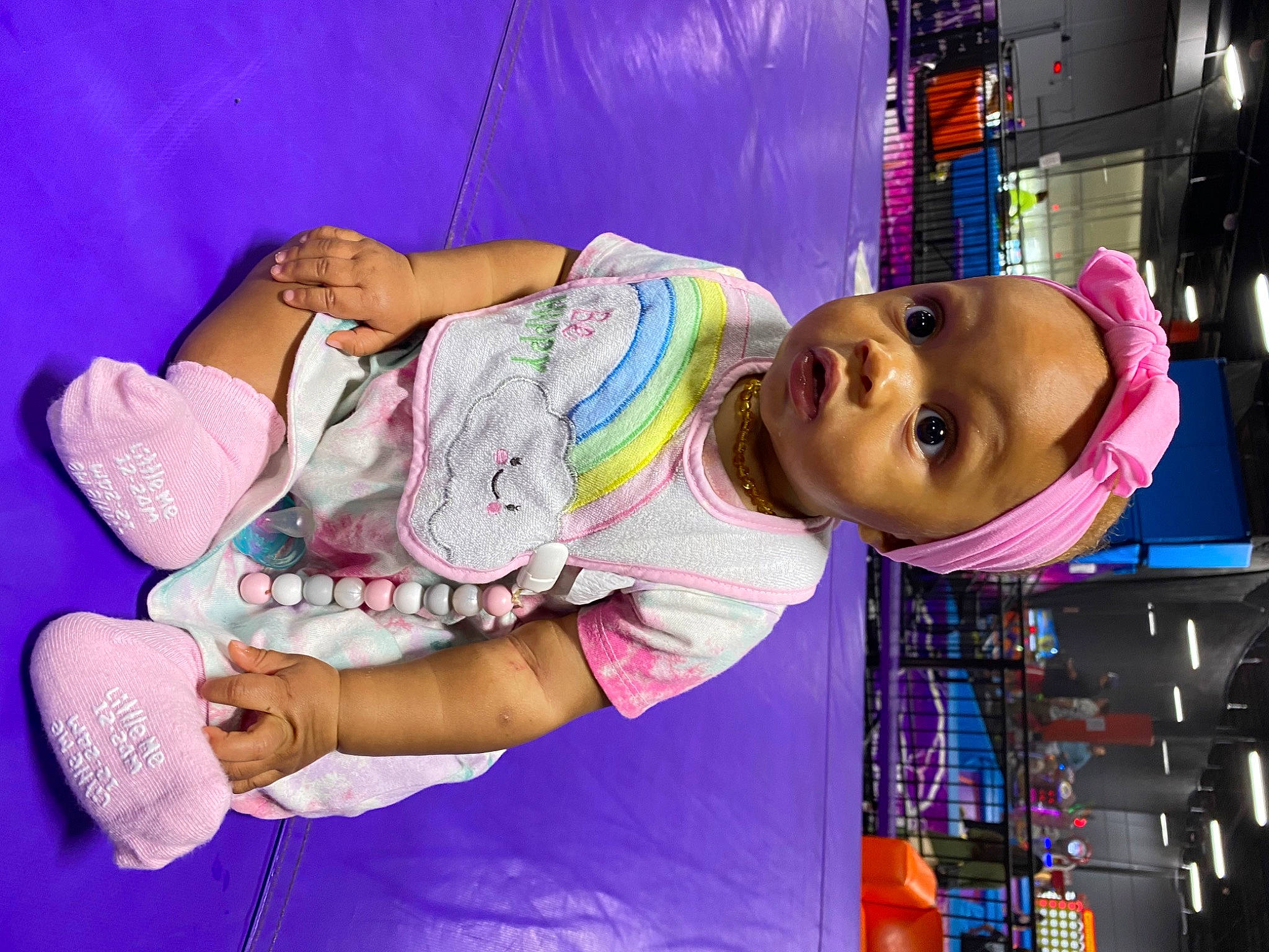 Journee is registered to the contest to win money with this photo: child, fun, happy, human_leg, knee, leisure, magenta, person, pink, purple, retail, room, sandal, sitting, skin, smile, sock, thigh, toddler