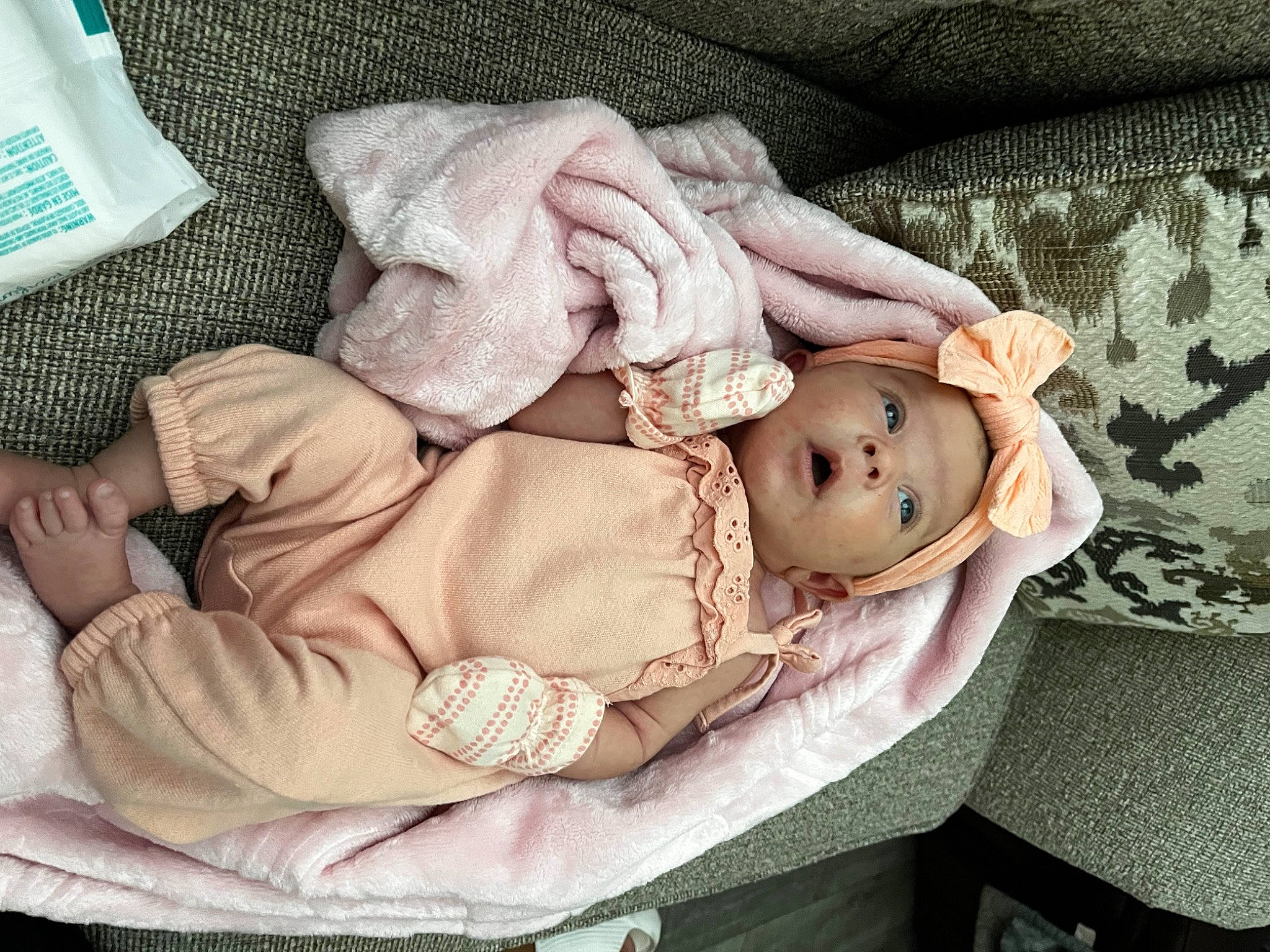 Blakely is registered to the contest to win money with this photo: baby, baby_products, baby_sleeping, baby_toddler_clothing, cheek, child, comfort, head, lap, linens, pattern, person, pink, product, sitting, skin, sleeve, textile, toddler, wood