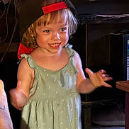Nevaeh is registered to the contest to win money with this photo: child, toddler, smiling, cap, dress, indoor, happy, motion, person, blond_hair, cute, young_child, playful, portrait, casual_clothing, warm_lighting, home, expression, face, human