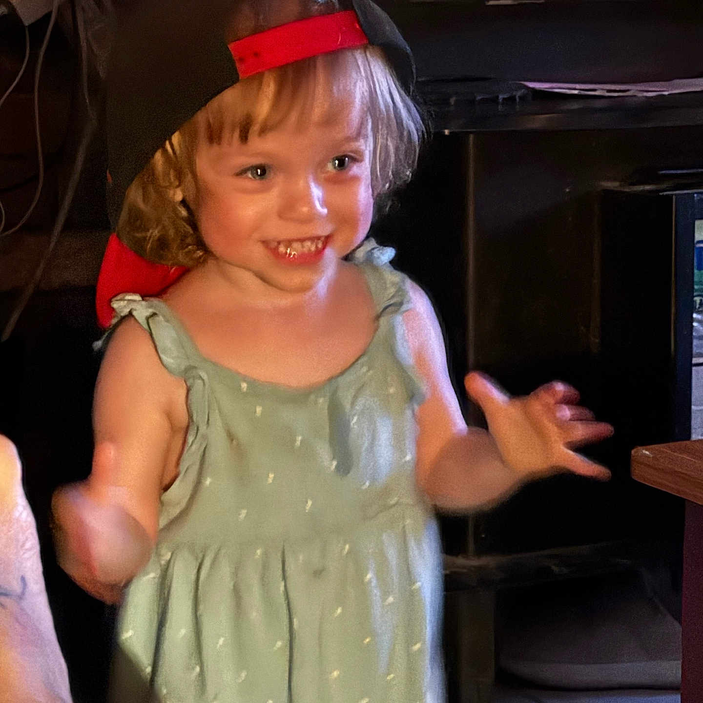 Nevaeh is registered to the contest to win money with this photo: blond_hair, cap, casual_clothing, child, cute, dress, expression, face, happy, home, human, indoor, motion, person, playful, portrait, smiling, toddler, warm_lighting, young_child