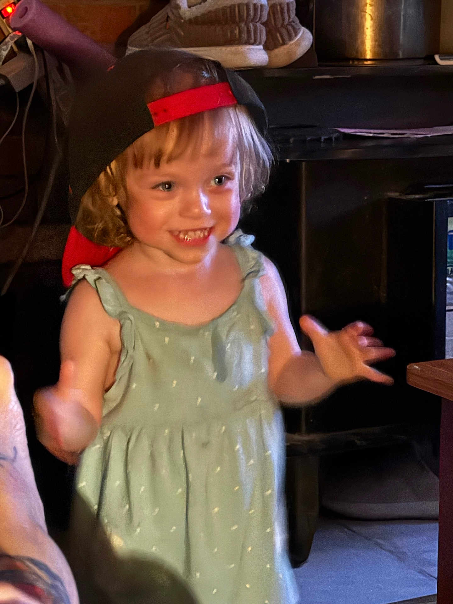 Nevaeh is registered to the contest to win money with this photo: child, toddler, smiling, cap, dress, indoor, happy, motion, person, blond_hair, cute, young_child, playful, portrait, casual_clothing, warm_lighting, home, expression, face, human