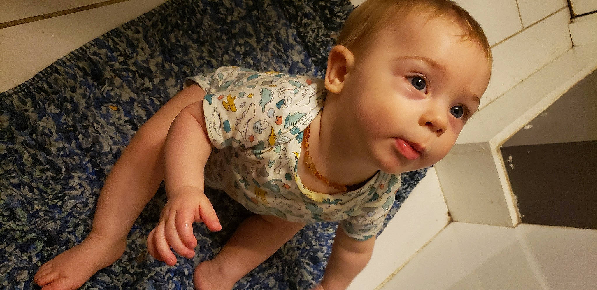 Malaki is registered to the contest to win money with this photo: arm, baby_toddler_clothing, cheek, comfort, finger, floor, flooring, head, human_body, iris, joint, mouth, muscle, neck, person, shoulder, skin, sleeve, thigh, toddler