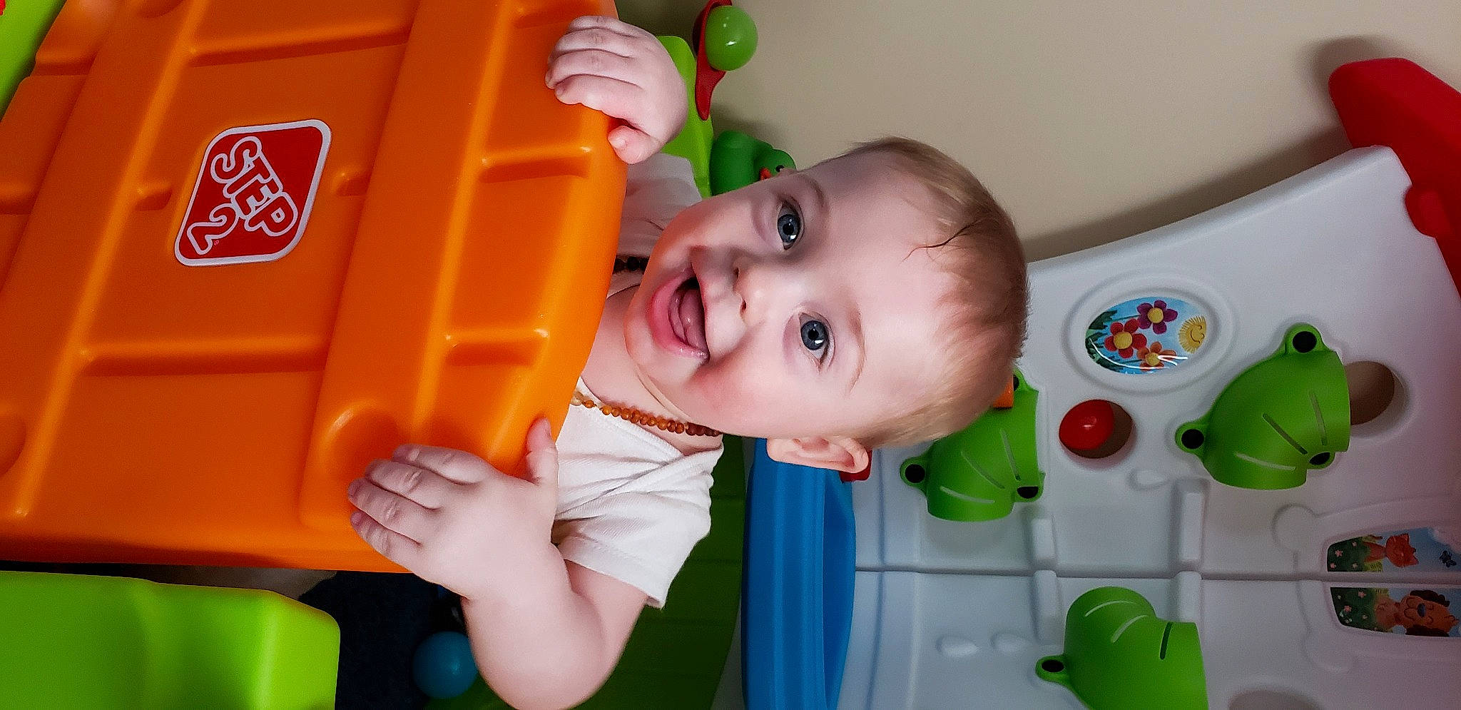 Malaki is registered to the contest to win money with this photo: baby, baby_playing_with_toys, baby_products, baby_toddler_clothing, baby_toys, cheek, child, finger, fun, green, happy, mouth, nose, person, play, skin, smile, standing, toddler, toy