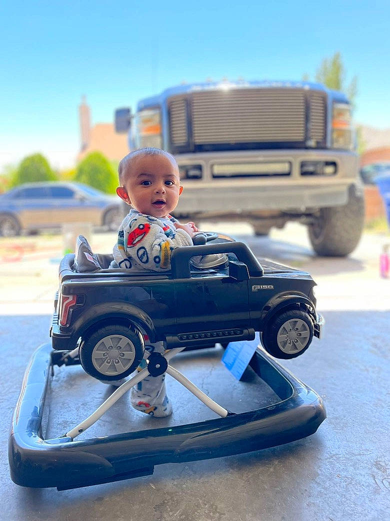 Gael is registered to the contest to win money with this photo: automotive_design, automotive_exterior, automotive_lighting, automotive_tire, bumper, car, fender, hood, mode_of_transport, motor_vehicle, person, riding_toy, rim, rolling, sky, tire, travel, tread, vehicle, vehicle_door