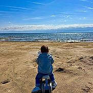 Milo participe au concours pour gagner de l'argent avec cette photo : beach, blue_sky, calm, child, clouds, denim_jacket, footprints, nature, outdoor, play, sand, sea, shadow, shoes, sky, sunlight, sunny, toddler, tricycle, water