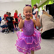 Braelynn joined the competition — help win amazing prizes! child, toddler, girl, ballet, tutu, purple_dress, bow, smile, happy, dance_class, studio, indoor, group, people, adults, floor, shoes, sequins, joyful, candid