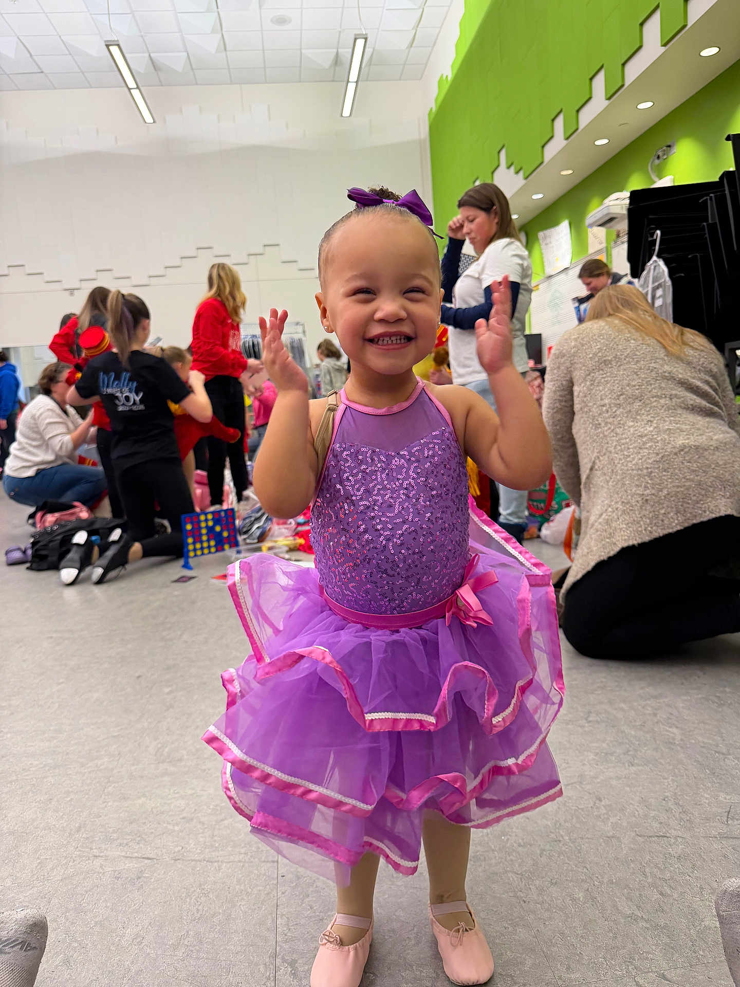 Braelynn joined the competition — help win amazing prizes! child, toddler, girl, ballet, tutu, purple_dress, bow, smile, happy, dance_class, studio, indoor, group, people, adults, floor, shoes, sequins, joyful, candid
