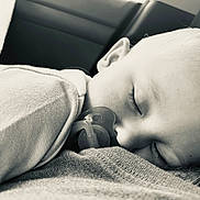 Weston is registered to the contest to win money with this photo: baby, sleeping, pacifier, closeup, black_and_white, child, infant, peaceful, soft_texture, clothing, face, portrait, cute, resting, young_child, monochrome, calm, comfort, head, eyelashes
