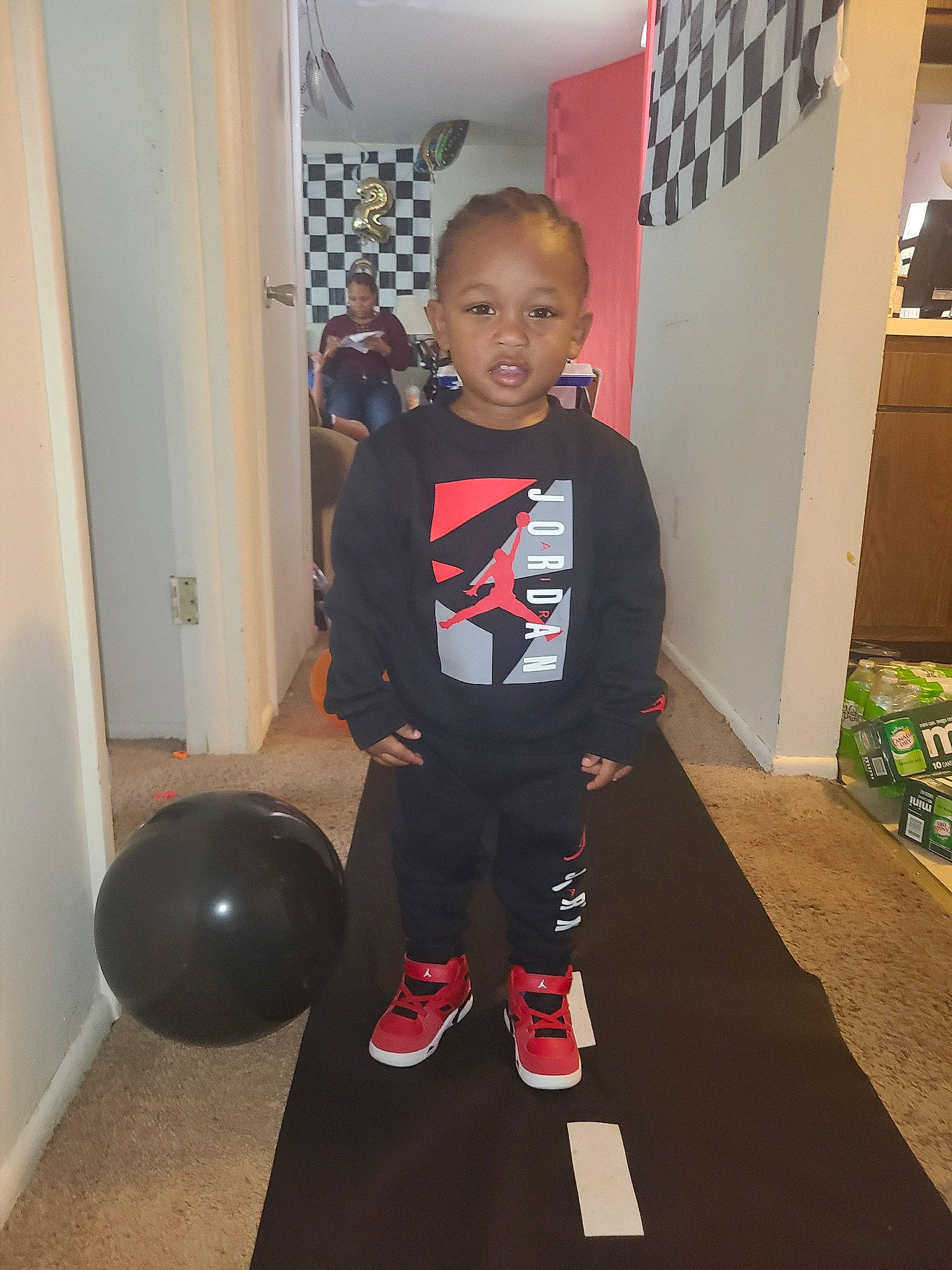 Yosiah joined the competition — help win amazing prizes! baby, balance, ball, child, floor, flooring, fun, hardwood, human_leg, joint, knee, person, physical_fitness, room, sports_equipment, sportswear, standing, sweatpant, t_shirt, thigh