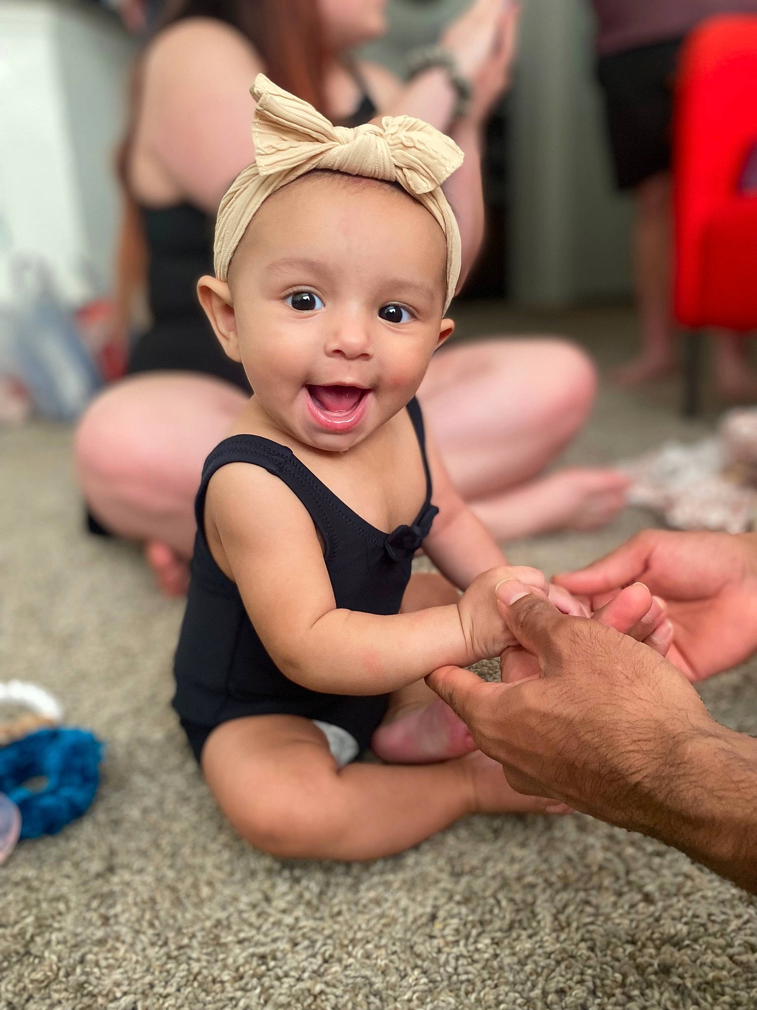 Jocelyn joined the competition — help win amazing prizes! baby, baby_toddler_clothing, cap, child, event, facial_expression, fashion_accessory, flooring, foot, fun, happy, human_leg, leisure, nail, person, pink, sitting, skin, smile, thumb