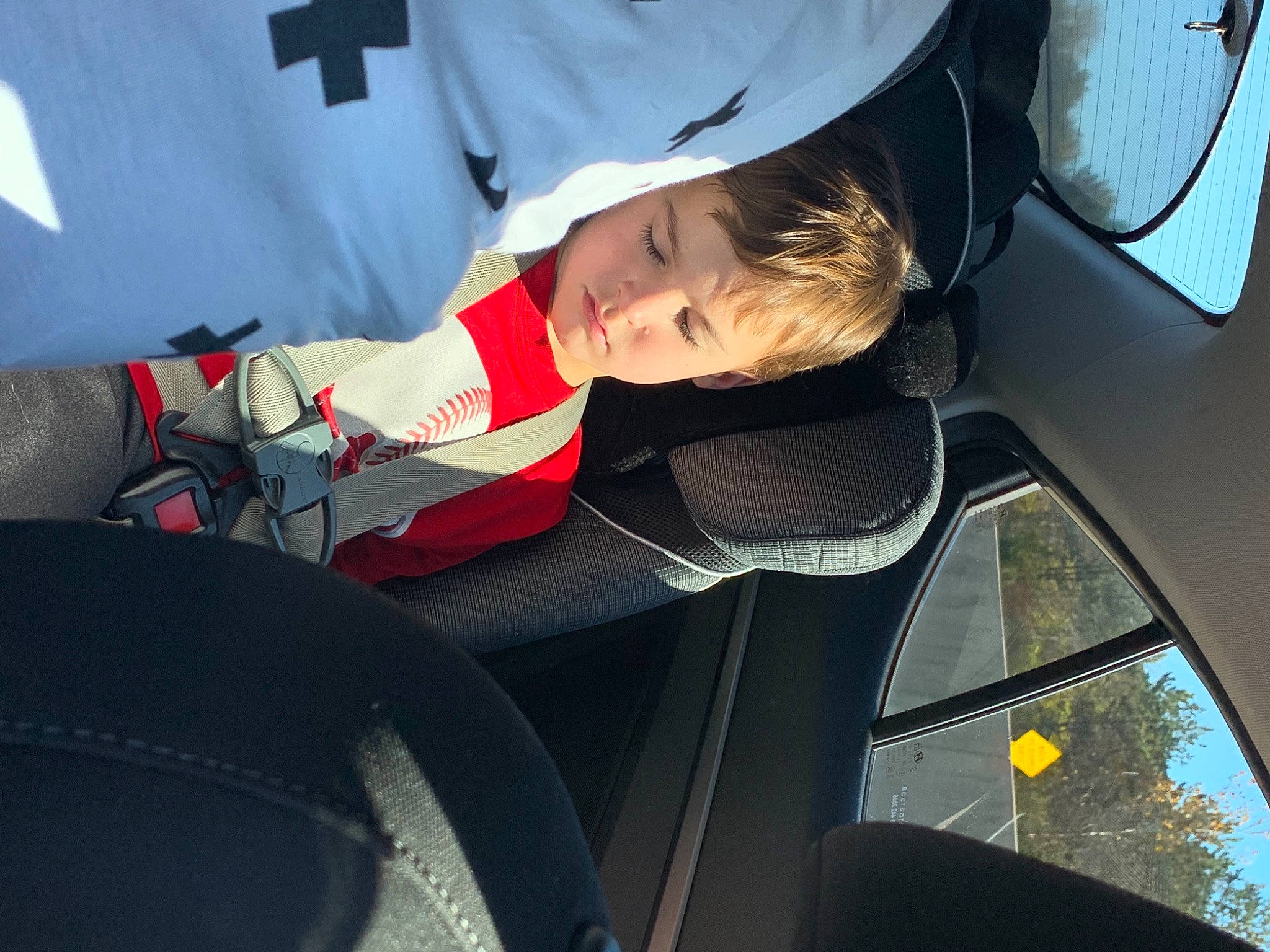 Leeland is registered to the contest to win money with this photo: automotive_window_part, baby, baby_products, baby_toddler_clothing, car_seat, carmine, child, comfort, motor_vehicle, passenger, person, public_transport, service, sun_hat, toddler, vehicle_door